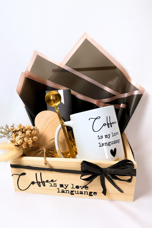 Kintoir Coffee Is My Love Language gift box featuring a ceramic mug, gold spoon, wooden coaster, and dried flowers.