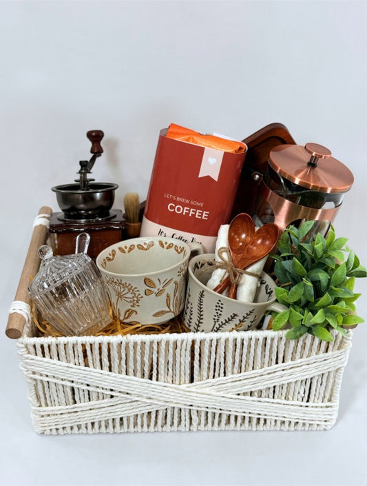 Kintoir copper French press coffee gift basket featuring ceramic mugs, wooden spoons, grinder, and coffee in a white bin