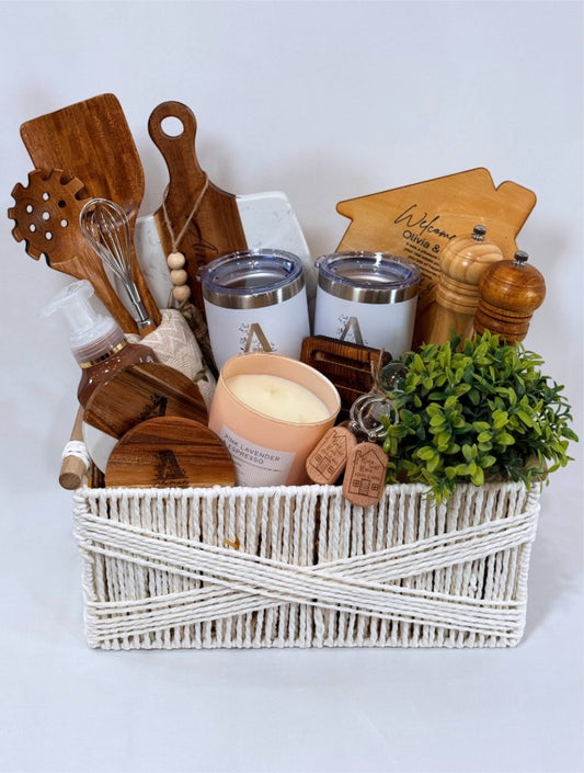 Kintoir luxury housewarming gift basket with personalized tumblers, engraved cutting board, and kitchen essentials.
