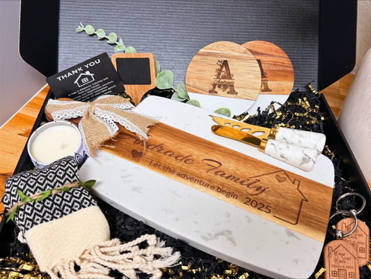Open personalized Realtor closing gift box with engraved cutting board, coasters, candle and kitchen accessories