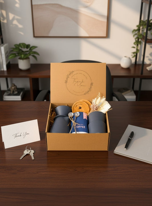 Kintoir coffee gift box featuring a pour-over maker, ceramic mugs, spoons, and dried flowers in a kraft box.