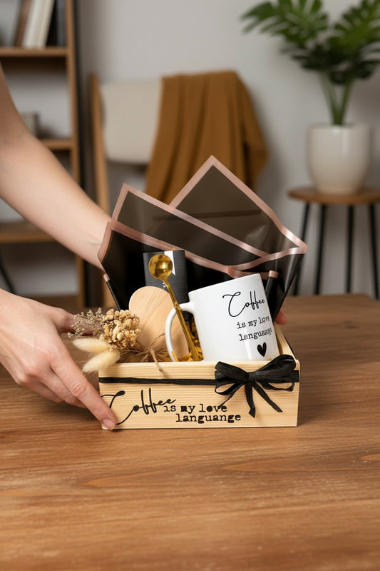 Kintoir Coffee Is My Love Language gift box featuring a ceramic mug, gold spoon, wooden coaster, and dried flowers.