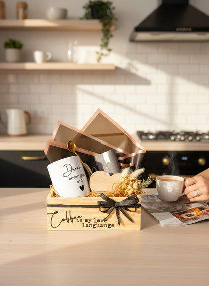 Kintoir Coffee Is My Love Language gift box featuring a ceramic mug, gold spoon, heart coaster, and dried flowers.