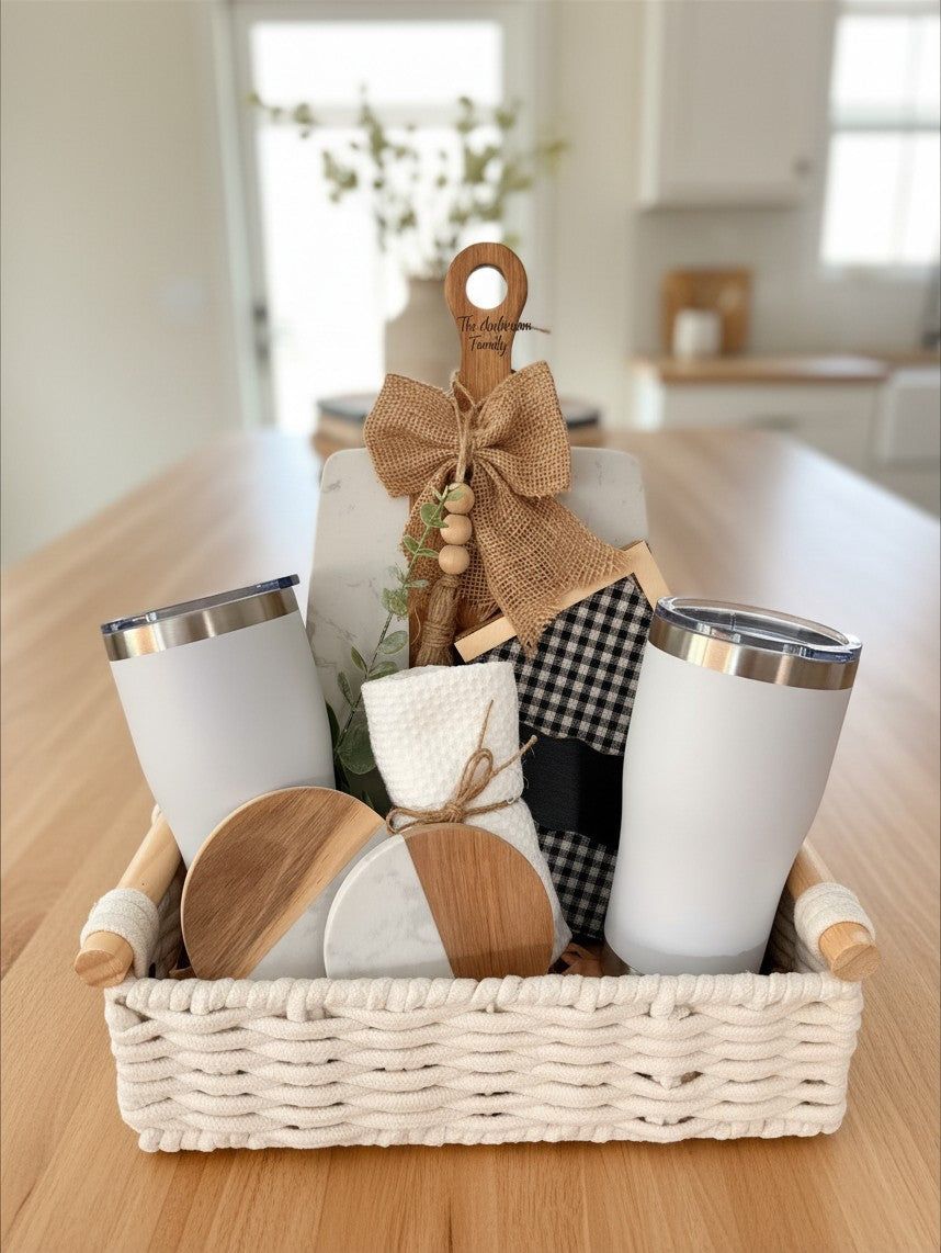 Ready-to-gift closing basket with tumblers and home accents displayed on a kitchen counter