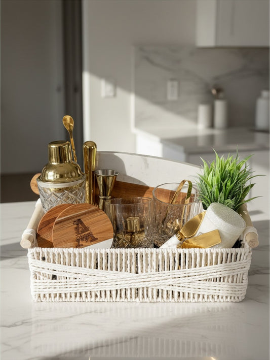 Golden Hour Entertainer personalized cocktail gift basket with gold barware, glassware, engraved cutting board, and greenery | Kintoir