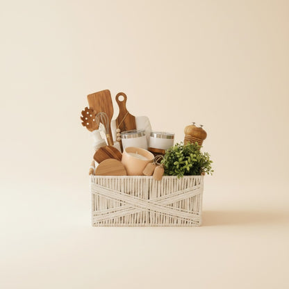 Kintoir Home Sweet Home gift basket featuring kitchen essentials, wooden utensils, and a faux plant in a white basket.