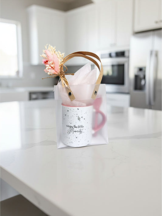 Kintoir Little Moments ceramic mug gift set in a frosted tote with dried flowers on a kitchen counter