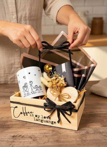 Kintoir personalized family coffee gift box featuring a custom illustrated mug, gold spoon, heart coaster, and flowers.