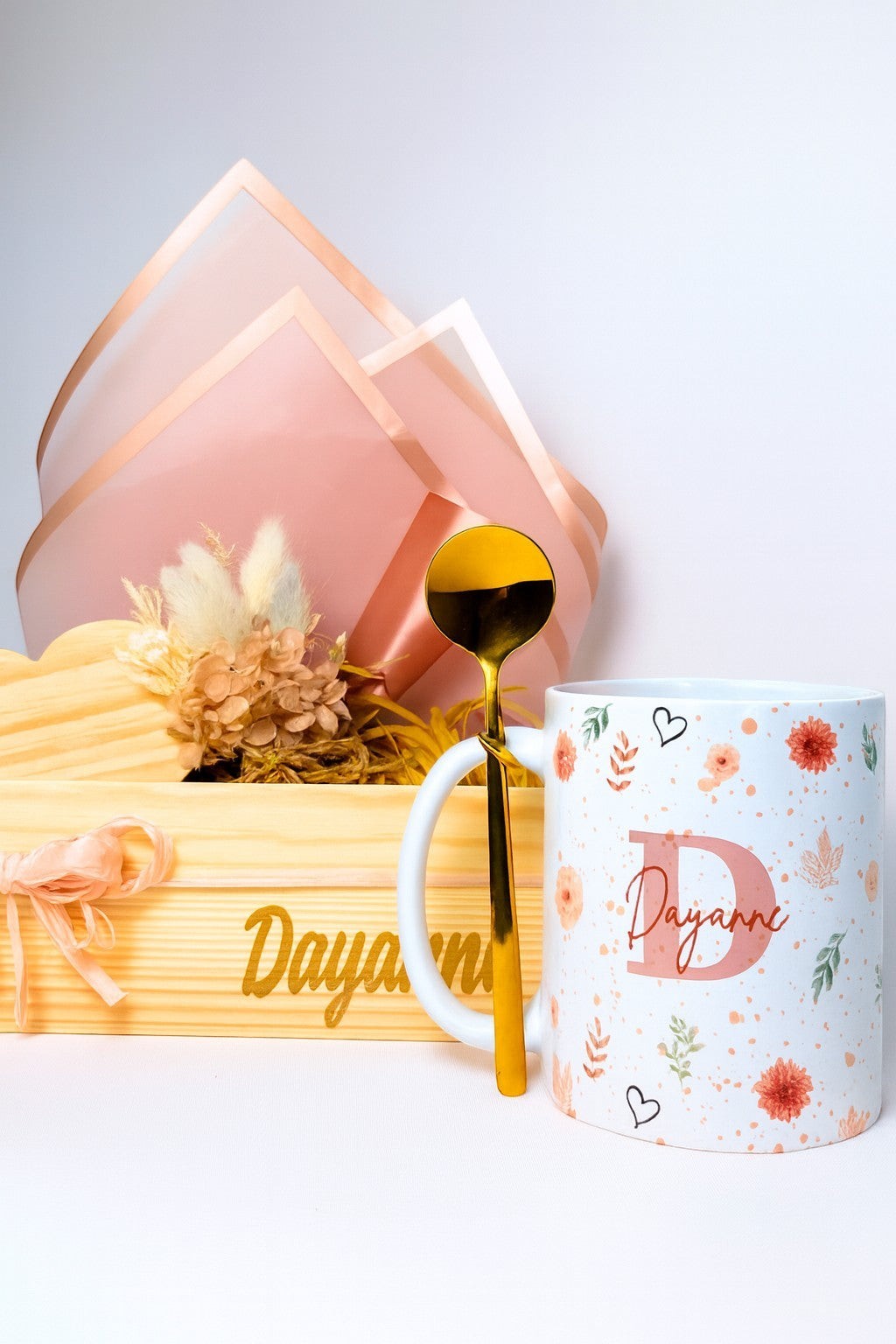 Kintoir personalized gift box featuring a floral mug, gold spoon, and dried flowers in a custom pine wood crate.
