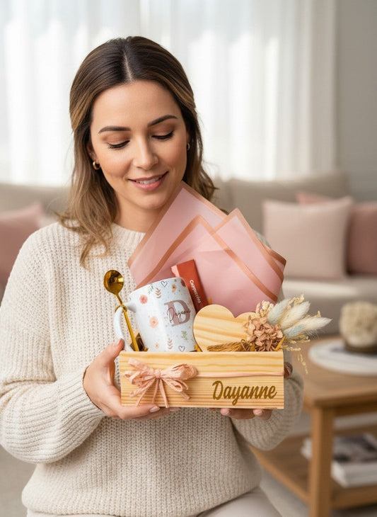 A woman holding a Kintoir personalized floral gift box featuring a custom mug, heart coaster, and dried flowers.