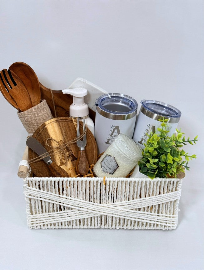 Kintoir personalized housewarming gift basket featuring engraved wooden boards, tumblers, candle, and kitchen essentials.