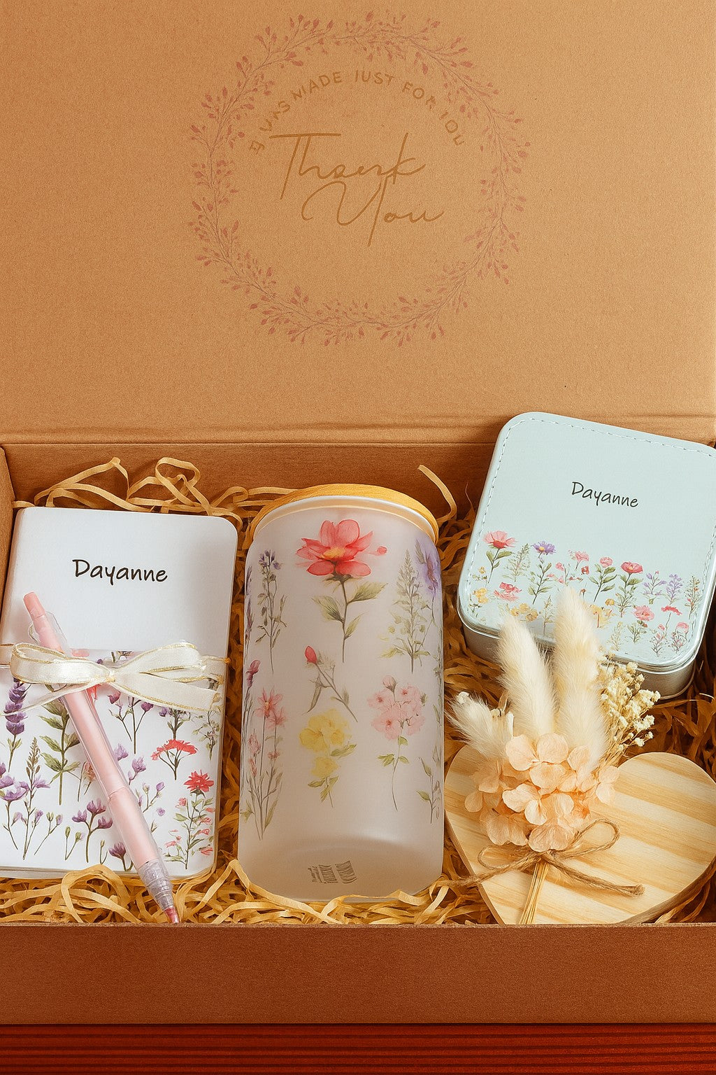 Kintoir personalized keepsake gift box featuring a floral notebook, glass tumbler, jewelry case, and wooden heart decor.
