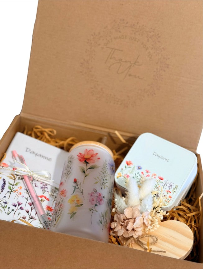 Kintoir personalized keepsake gift box featuring a floral glass tumbler, notebook, jewelry case, and dried flowers.