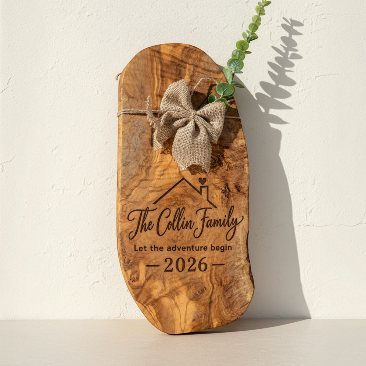 Personalized olive wood closing gift board with burlap bow, greenery and engraved new homeowner design