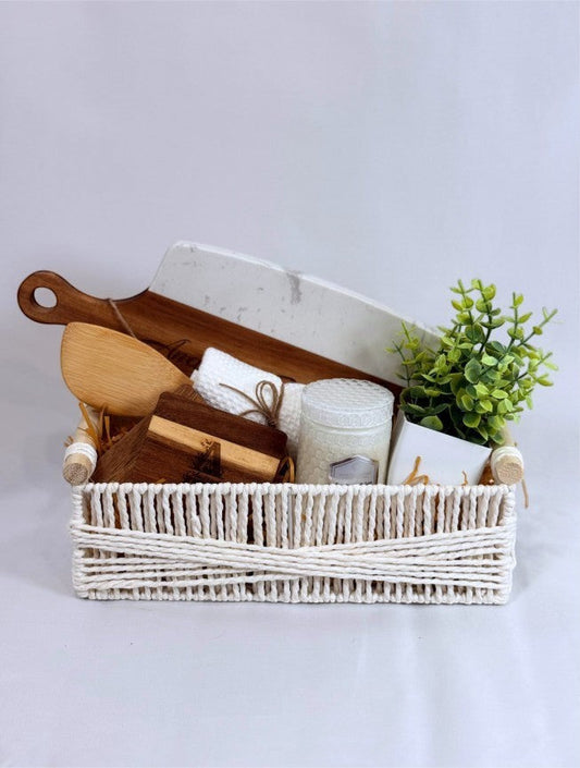 Personalized closing gift basket with engraved cutting board, coasters, candle, towel and greenery