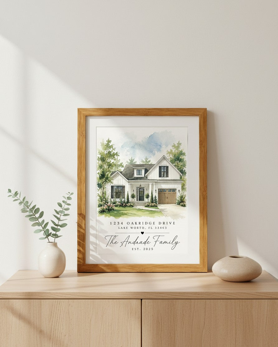Kintoir personalized watercolor home portrait in a wooden frame displayed on a light wood console table.