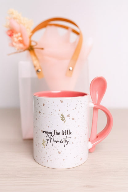 Kintoir speckled ceramic mug with pink interior, spoon, and quote, presented with a frosted gift tote and flowers.
