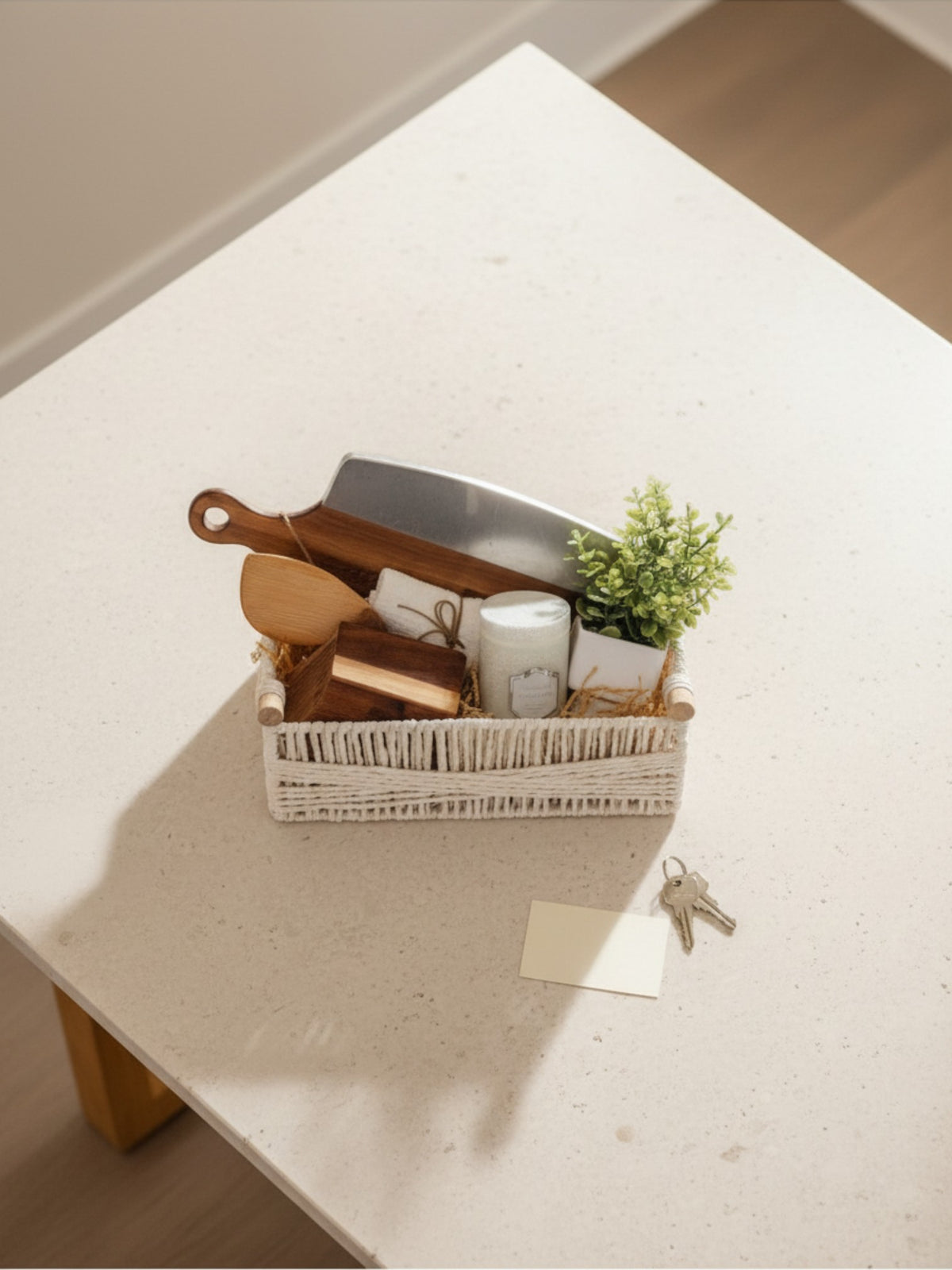 New homeowner gift basket with neutral kitchen accessories and candle